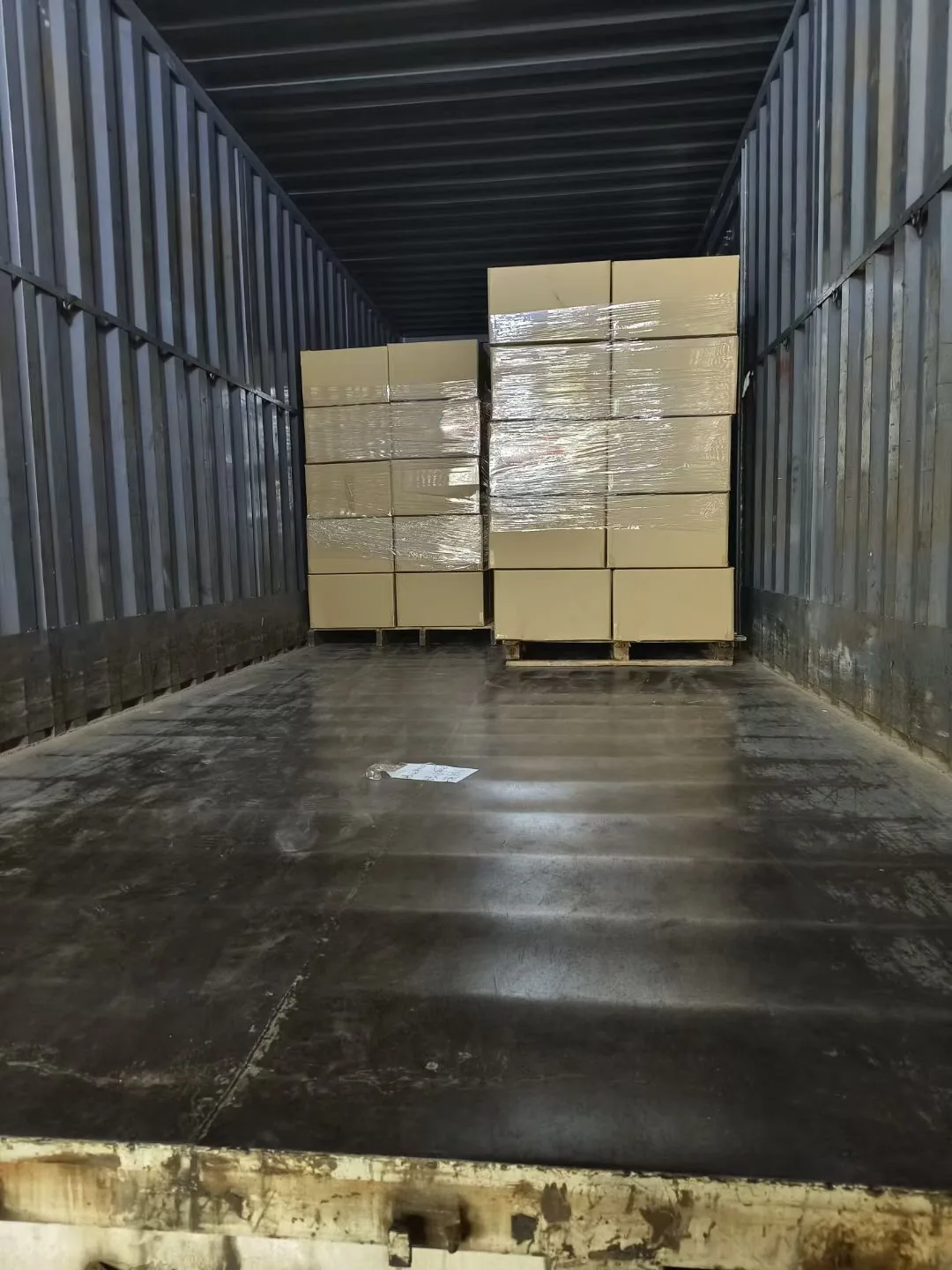 Palletized cartons secured inside a delivery truck